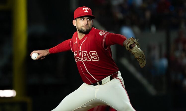 Texas Rangers starting pitcher Nathan Eovaldi rocks into his delivery with the ball hidden behind his hip.