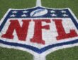 The NFL shield logo painted on the field at Tom Benson Hall of Fame Stadium.