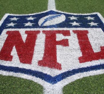 The NFL shield logo painted on the field at Tom Benson Hall of Fame Stadium.