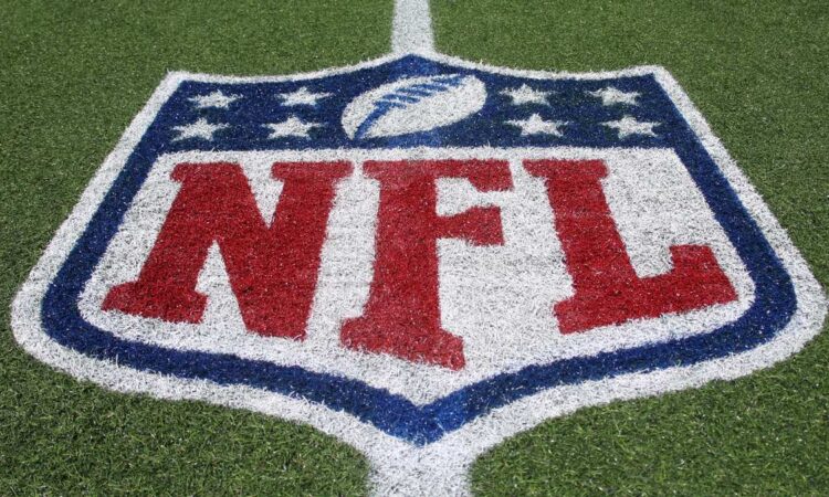 The NFL shield logo painted on the field at Tom Benson Hall of Fame Stadium.