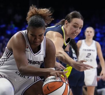 Toronto Tempo forward Nyara Sabally pulls the ball away as Dallas Wings forward Alanna Smith reaches in.