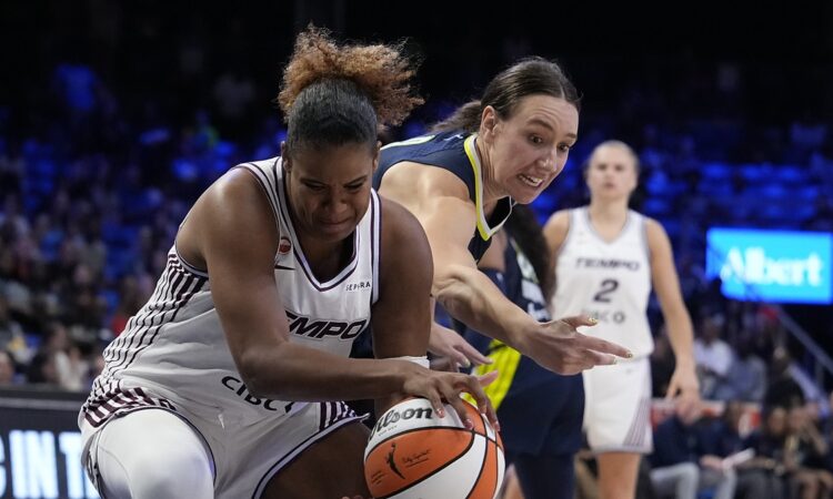 Toronto Tempo forward Nyara Sabally pulls the ball away as Dallas Wings forward Alanna Smith reaches in.