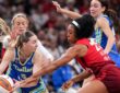 Dallas Wings guard Paige Bueckers protects the ball as two Indiana Fever defenders converge on her.