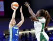 Dallas Wings guard Paige Bueckers rises for a shot as Storm center Awa Fam contests at College Park Center.