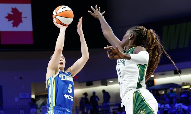 Dallas Wings guard Paige Bueckers rises for a shot as Storm center Awa Fam contests at College Park Center.
