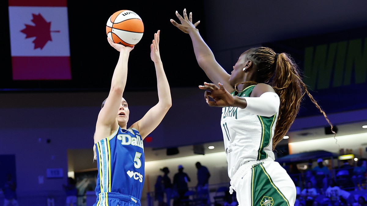 Dallas Wings guard Paige Bueckers rises for a shot as Storm center Awa Fam contests at College Park Center.