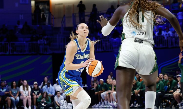 Dallas Wings guard Paige Bueckers rises for a shot as Storm center Awa Fam contests at College Park Center.