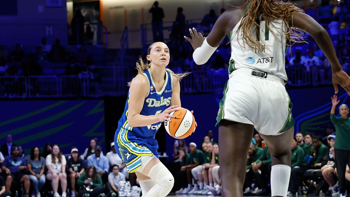 Dallas Wings guard Paige Bueckers rises for a shot as Storm center Awa Fam contests at College Park Center.