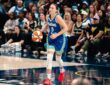 Dallas Wings guard Paige Bueckers dribbles up the floor in a blue Dallas jersey during a game.