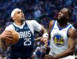 Dallas Mavericks forward P.J. Washington gathers the ball to drive as Golden State Warriors forward Draymond Green defends.