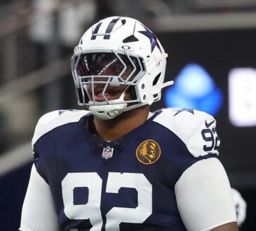 Dallas Cowboys defensive tackle Quinnen Williams stands in full pads during pregame warmups at AT&T Stadium.