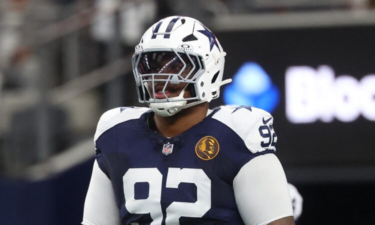 Dallas Cowboys defensive tackle Quinnen Williams stands in full pads during pregame warmups at AT&T Stadium.