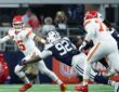 Cowboys defensive tackle Quinnen Williams lunges at Chiefs quarterback Patrick Mahomes as he escapes the pocket