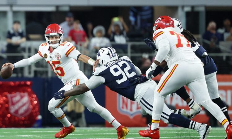 Cowboys defensive tackle Quinnen Williams lunges at Chiefs quarterback Patrick Mahomes as he escapes the pocket
