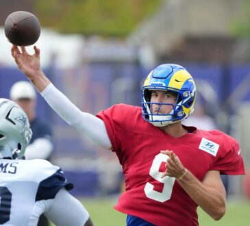 Cowboys defensive tackle Quinnen Williams closes on Rams quarterback Matthew Stafford as he throws in joint practice