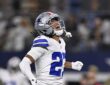 Dallas Cowboys cornerback Reddy Steward throws his head back and shouts, fist clenched, after a sack.