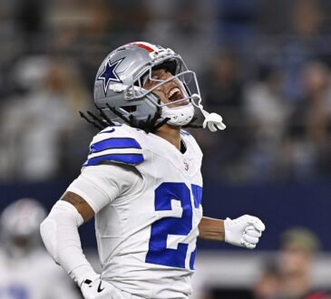 Dallas Cowboys cornerback Reddy Steward throws his head back and shouts, fist clenched, after a sack.