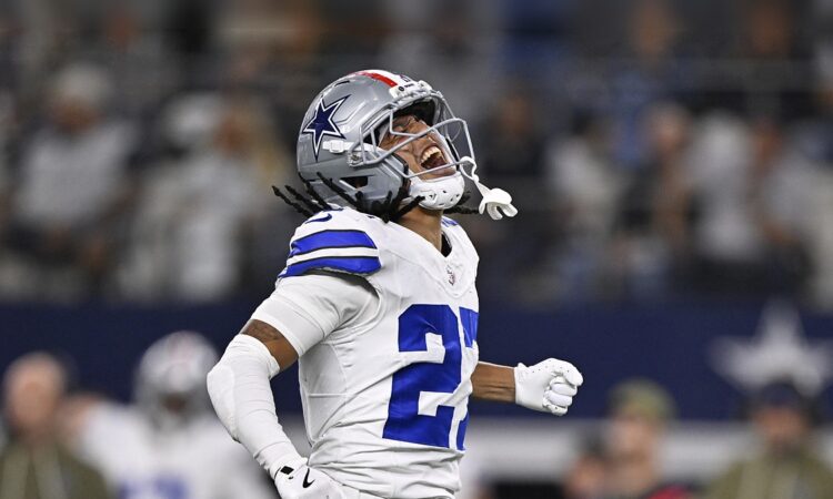 Dallas Cowboys cornerback Reddy Steward throws his head back and shouts, fist clenched, after a sack.
