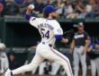 Texas Rangers pitcher Robby Ahlstrom drives toward the plate with his name and number facing the camera at Globe Life Field.
