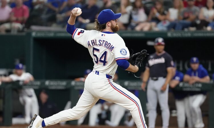 Texas Rangers pitcher Robby Ahlstrom drives toward the plate with his name and number facing the camera at Globe Life Field.