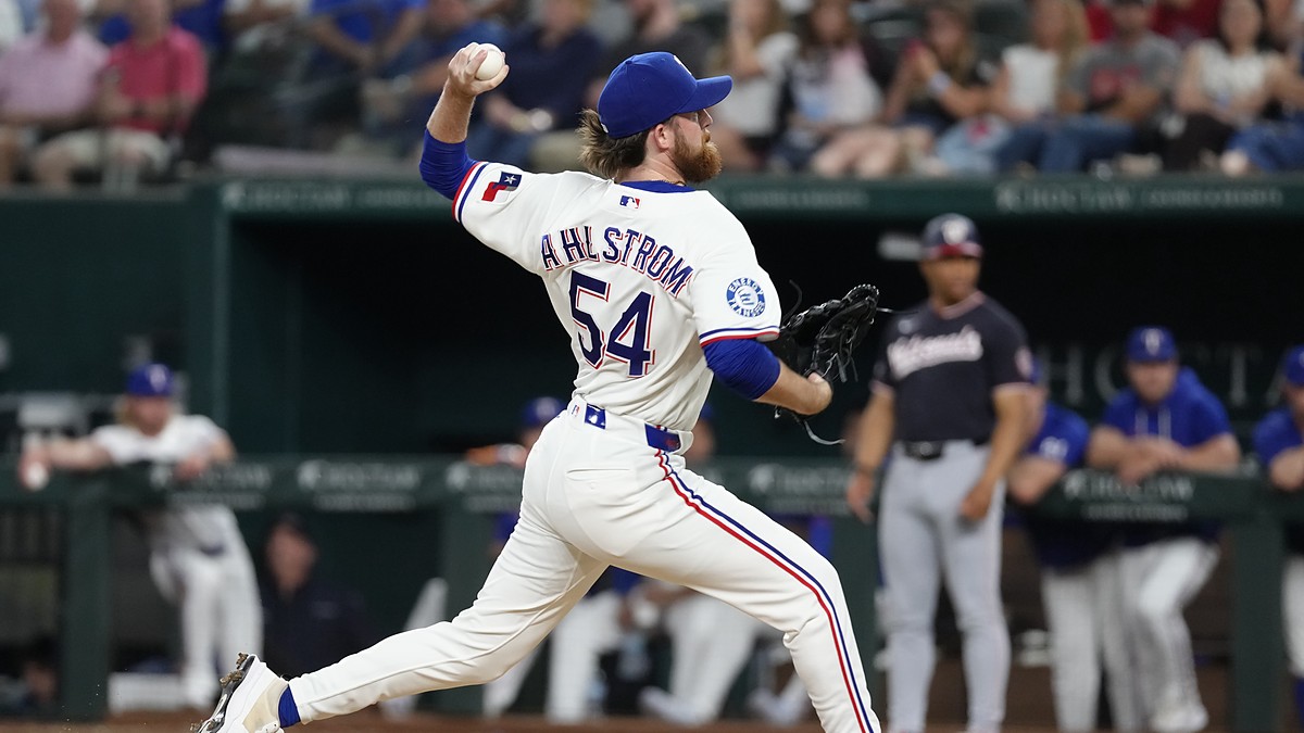Texas Rangers pitcher Robby Ahlstrom drives toward the plate with his name and number facing the camera at Globe Life Field.