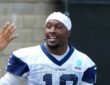 Dallas Cowboys wide receiver Ryan Flournoy smiles as he talks with fans reaching for autographs at training camp.