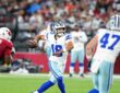 Dallas Cowboys quarterback Sam Howell throws downfield as a Cardinals lineman closes in.