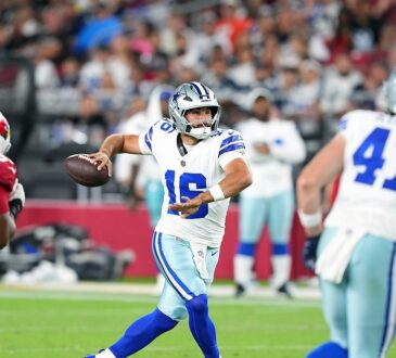 Dallas Cowboys quarterback Sam Howell throws downfield as a Cardinals lineman closes in.