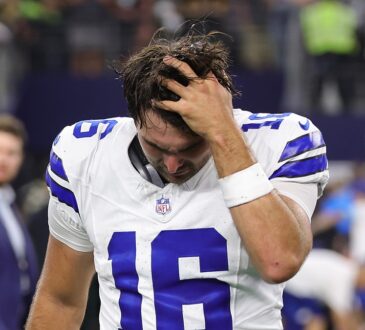 Alt Text: Dallas Cowboys quarterback Sam Howell runs a hand through his hair with his head down after the game.