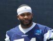 Dallas Cowboys edge rusher Sam Williams stands in a No. 54 practice jersey at training camp.