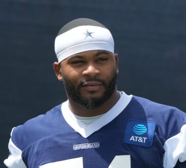 Dallas Cowboys edge rusher Sam Williams stands in a No. 54 practice jersey at training camp.