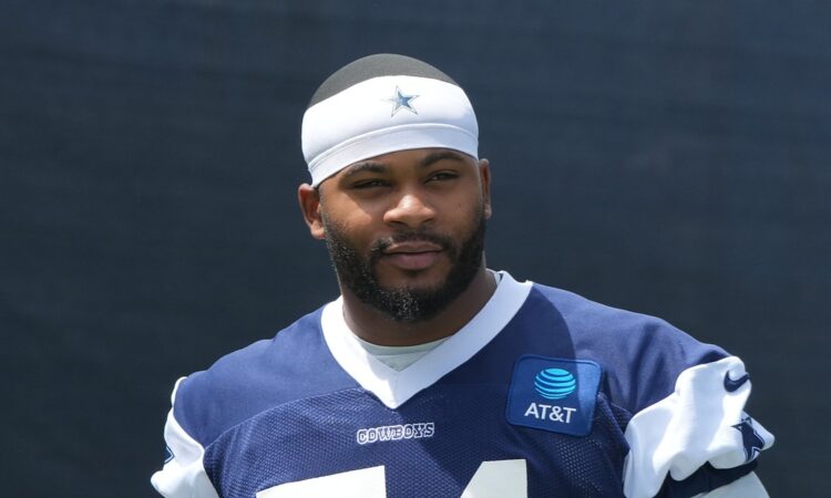 Dallas Cowboys edge rusher Sam Williams stands in a No. 54 practice jersey at training camp.
