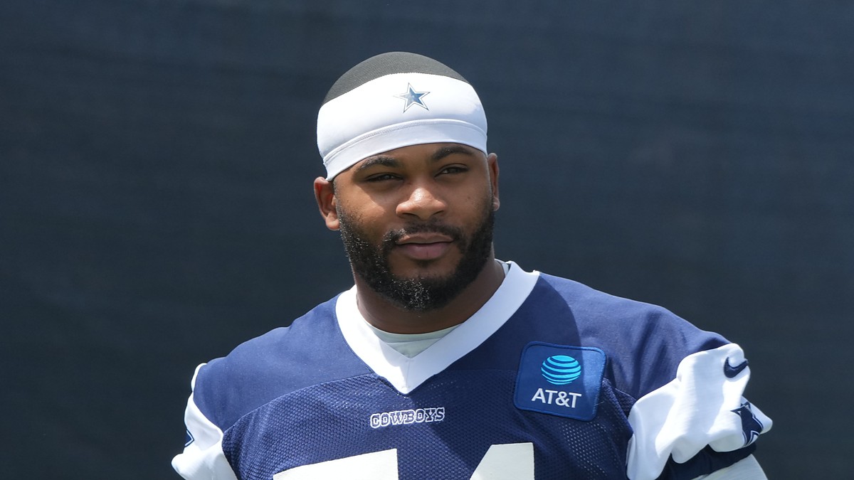 Dallas Cowboys edge rusher Sam Williams stands in a No. 54 practice jersey at training camp.