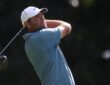 Scottie Scheffler holds his follow-through with a driver, watching the ball in flight during the final round.