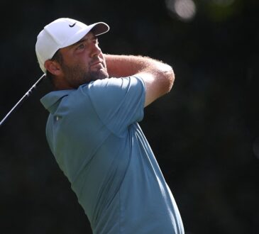 Scottie Scheffler holds his follow-through with a driver, watching the ball in flight during the final round.
