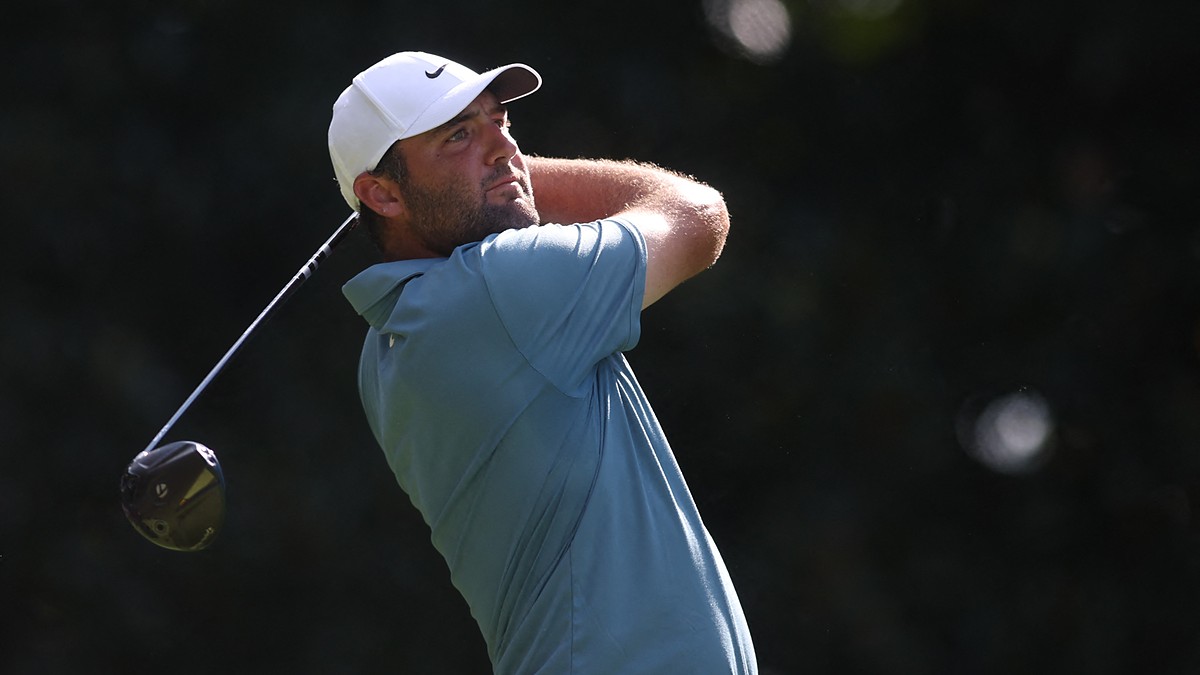 Scottie Scheffler holds his follow-through with a driver, watching the ball in flight during the final round.
