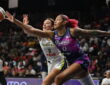 Washington Mystics center Shakira Austin and Dallas Wings forward Alanna Smith stretch for a loose ball.