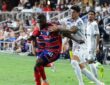 FC Dallas defender Shaq Moore holds off a Querétaro midfielder while dribbling along the touchline
