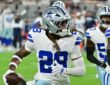 Dallas Cowboys cornerback Shavon Revel Jr. carries the ball upfield after an interception as teammates trail him.