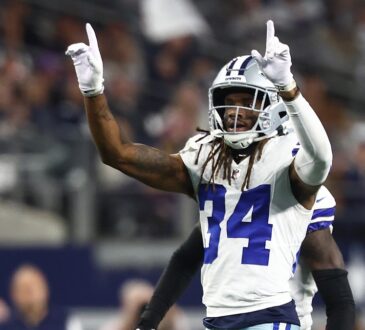 Dallas Cowboys cornerback Shavon Revel Jr. raises both index fingers to celebrate a play against the Minnesota Vikings.