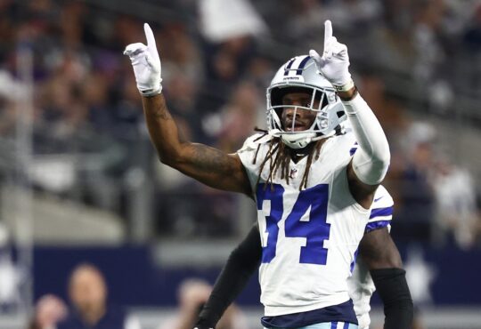 Dallas Cowboys cornerback Shavon Revel Jr. raises both index fingers to celebrate a play against the Minnesota Vikings.