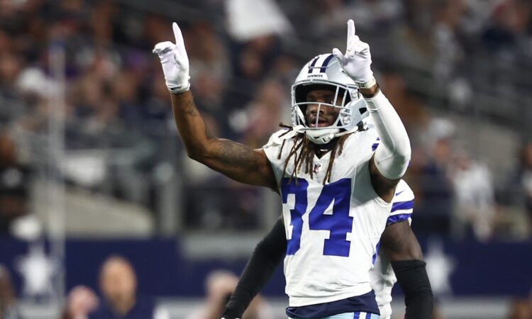 Dallas Cowboys cornerback Shavon Revel Jr. raises both index fingers to celebrate a play against the Minnesota Vikings.
