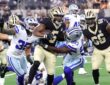 Dallas Cowboys linebacker Shemar James wraps up New Orleans Saints running back Kendre Miller in the backfield.