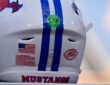 The red ACC logo decal on the back of a white SMU Mustangs football helmet with blue center stripes.