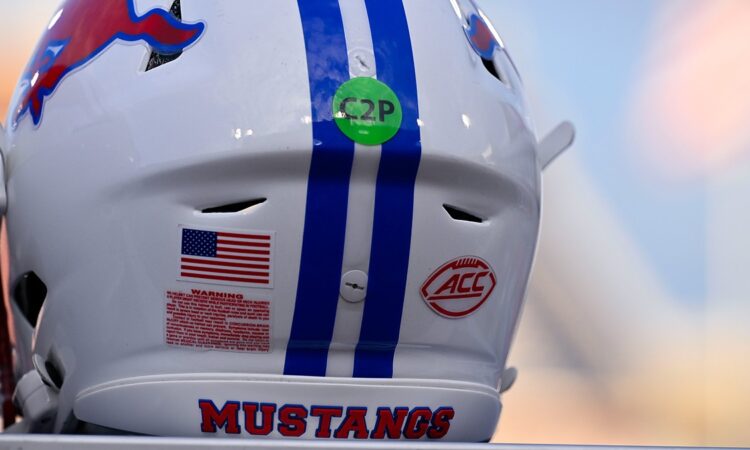 The red ACC logo decal on the back of a white SMU Mustangs football helmet with blue center stripes.