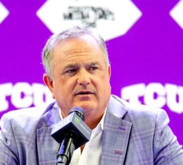 TCU head coach Sonny Dykes speaks into a microphone at a podium during Big 12 media days.