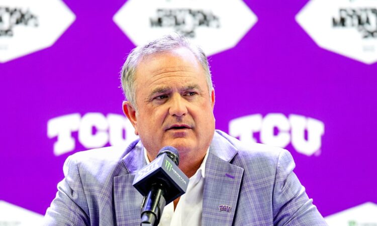 TCU head coach Sonny Dykes speaks into a microphone at a podium during Big 12 media days.