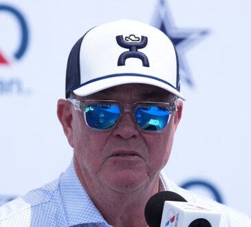 Cowboys executive vice president Stephen Jones speaks into a microphone at the training camp opening press conference