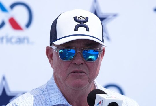 Cowboys executive vice president Stephen Jones speaks into a microphone at the training camp opening press conference