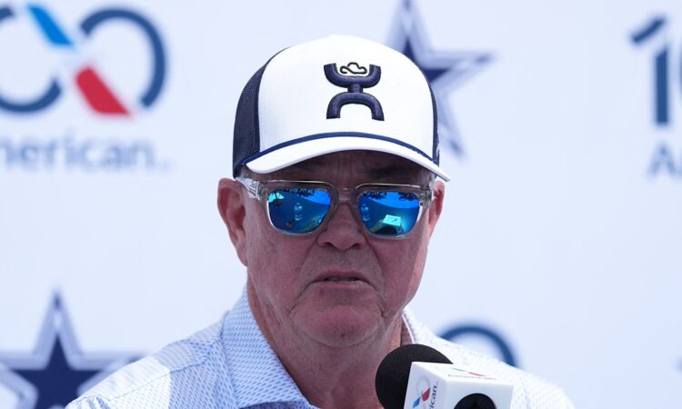 Cowboys executive vice president Stephen Jones speaks into a microphone at the training camp opening press conference